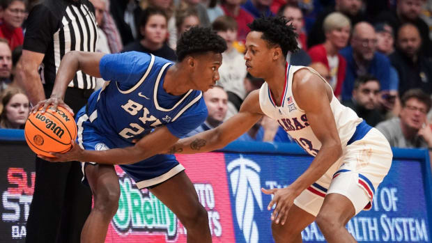 Feb 27, 2024; Lawrence, Kansas, USA; Brigham Young Cougars guard Jaxson Robinson (2) controls the ball as Kansas Jayhawks guard Elmarko Jackson (13) defends during the second half at Allen Fieldhouse.